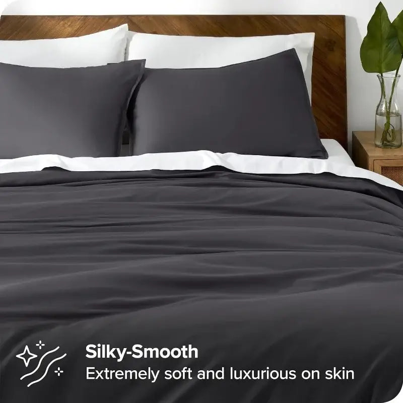 Blue Satin Duvet Cover Set by Decorbites on a bed with white sheets and dark pillow shams on Tampa Home & Garden Store