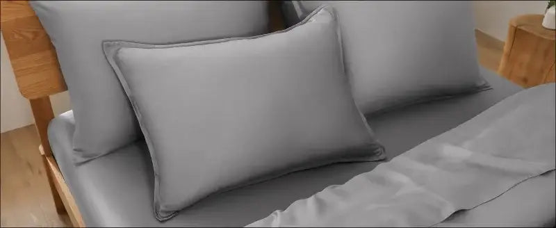 Duvet cover set in gray satin with matching pillows on bed on Tampa Home & Garden Store