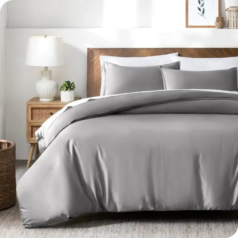 Blue Satin Duvet Cover Set by Decorbites in gray-blue satin with matching shams on a bed on Tampa Home & Garden Store