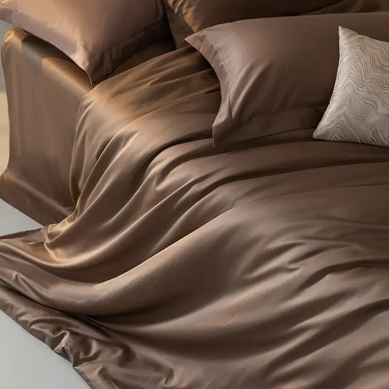 Duvet cover set in taupe satin by Decorbites on bed with two matching pillowcases on Tampa Home & Garden Store
