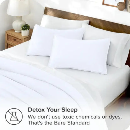 Blue satin duvet cover set by Decorbites on white bedding with pillows on Tampa Home & Garden Store