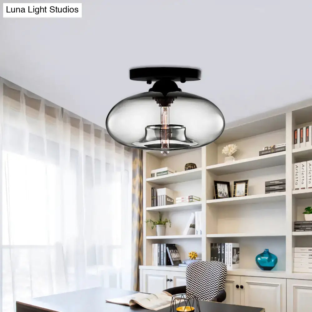 Glass oval flush mount ceiling light with clear glass shade and black canopy in a home office on Tampa Home & Garden Store
