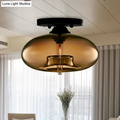Glass oval flush mount light with amber smoked glass shade and black canopy on Tampa Home & Garden Store