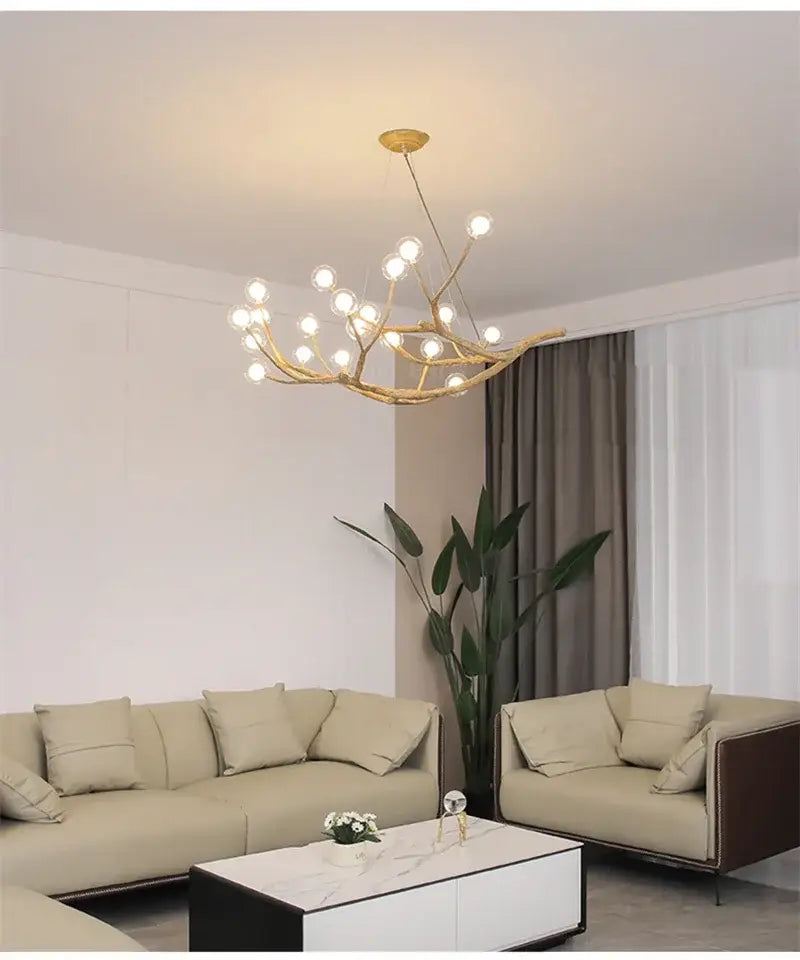 Chandelier Decorbites golden iron tree-branch bubble chandelier with bulbs over beige sofas on Tampa Home & Garden Store