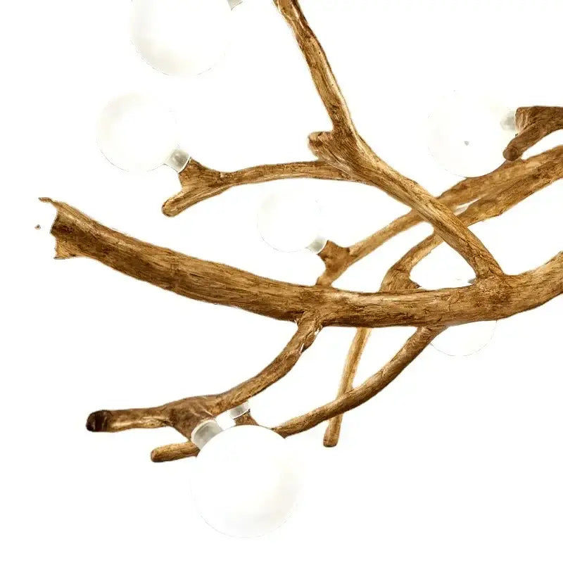 Golden iron tree-branch chandelier with white glass globe bulbs on Tampa Home & Garden Store