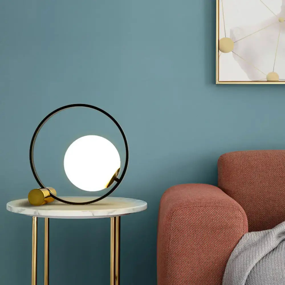 Black Gold Ball Lamp with white globe inside circular black ring and gold base on marble side table on Tampa Home & Garden Store