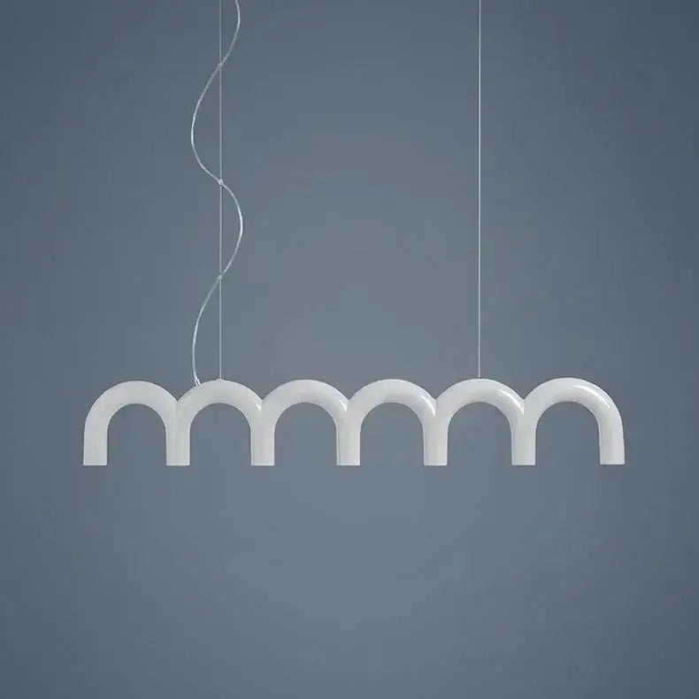 Modern white u-shaped chandelier with six arches suspended by thin cables on Tampa Home & Garden Store