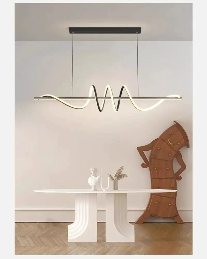 Decorbites Sleek wavy pendant lights with brushed metallic finish above dining table on Tampa Home & Garden Store