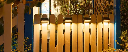 Modern black solar-powered fence lights by Decorbites six lights along white picket fence on Tampa Home & Garden Store