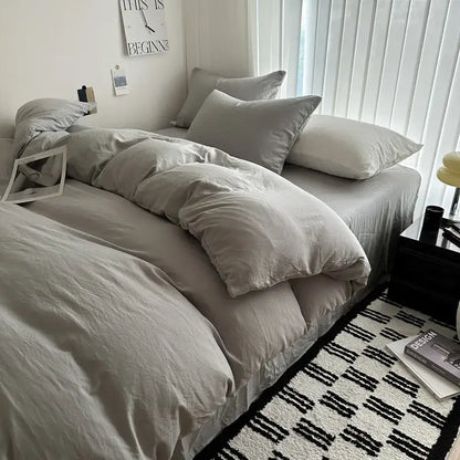 Gray quilted cotton duvet cover by Decorbites in a minimalist bed setup with matching pillows on Tampa Home & Garden Store