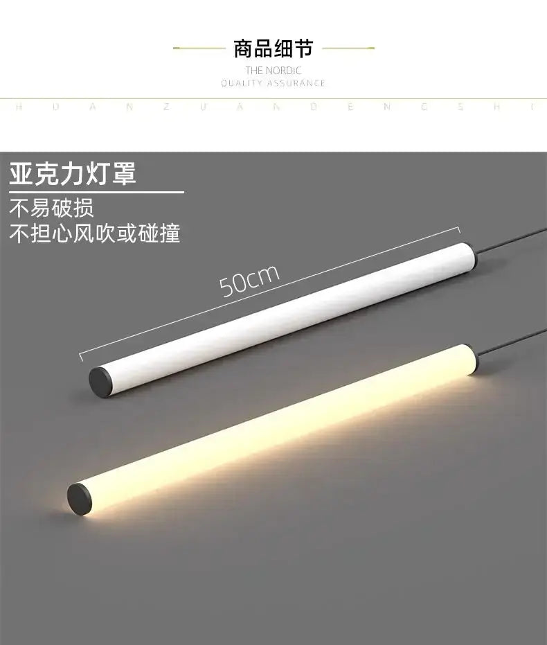 Two 50cm cylindrical LED pendant lights, white bodies with black ends, one lit warm white on Tampa Home & Garden Store