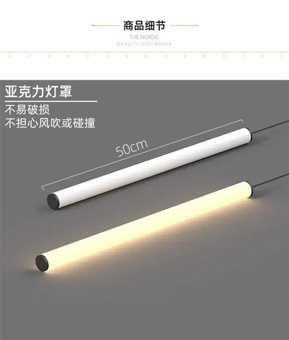 Two 50cm cylindrical LED pendant lights, white bodies with black ends, one lit warm white on Tampa Home & Garden Store