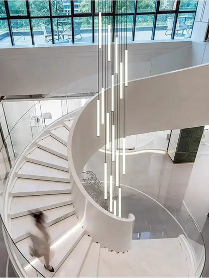 Decorbites modern black spiral LED chandelier with vertical tubes above a spiral staircase on Tampa Home & Garden Store