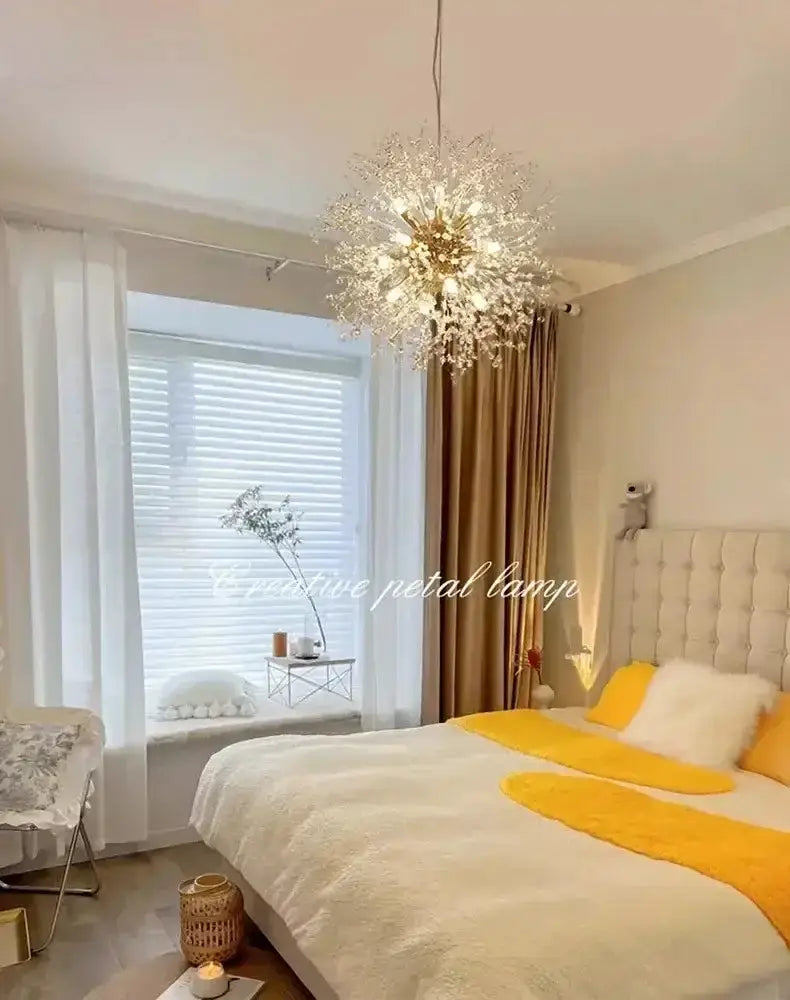 Decorbites golden dandelion crystal pendant light above a white bed with yellow accents on Tampa Home & Garden Store