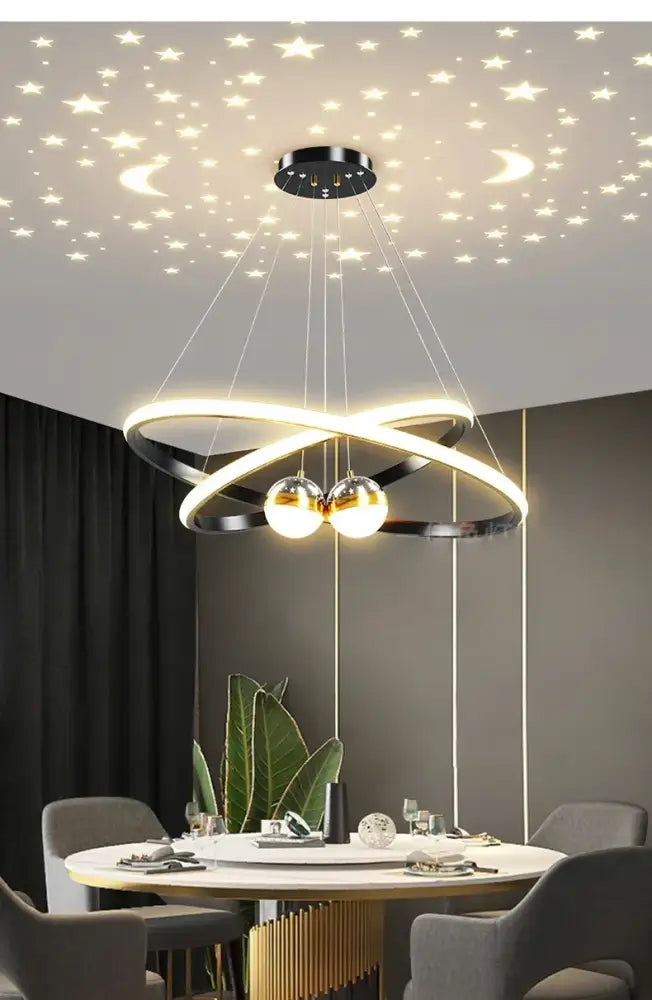 Black Gold Ring Chandelier by Decorbites with glowing intertwined rings and two spheres on Tampa Home & Garden Store