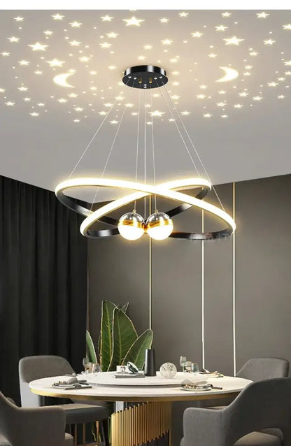 Black Gold Ring Chandelier by Decorbites with glowing intertwined rings and two spheres on Tampa Home & Garden Store