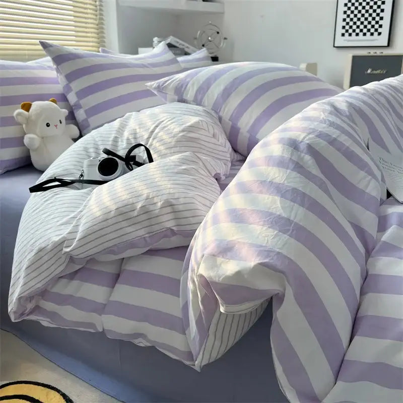 Cream striped quilted duvet cover set by Decorbites in lavender-white stripes on bed on Tampa Home & Garden Store