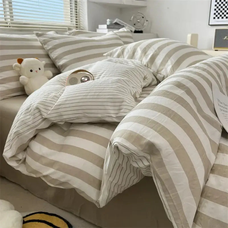 Cream Striped Quilted Quilt by Decorbites, beige striped bedding on a cozy bed setup on Tampa Home & Garden Store