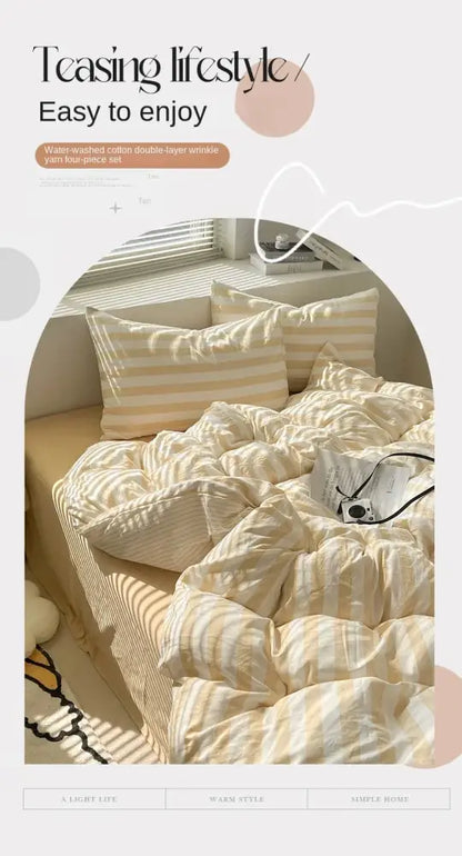 Cream striped quilt with matching striped pillows by Decorbites on a sunlit bed on Tampa Home & Garden Store