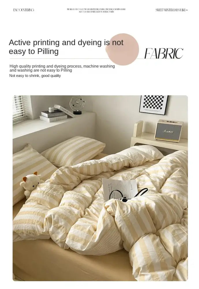 Cream striped quilted quilt by Decorbites on bed with two striped pillows in a cozy bedroom on Tampa Home & Garden Store