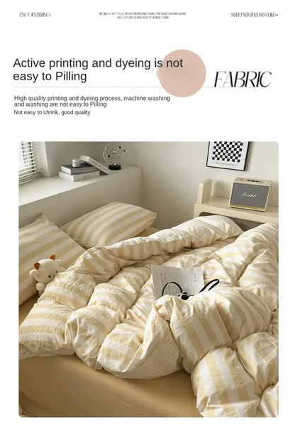 Cream striped quilted quilt by Decorbites on bed with two striped pillows in a cozy bedroom on Tampa Home & Garden Store
