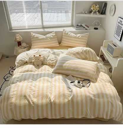 Cream Striped Quilted Quilt duvet cover set with beige striped pillows on a sunlit bedroom bed on Tampa Home & Garden Store
