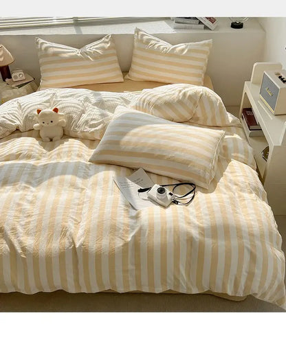 Decorbites cream striped quilted duvet cover set on bed with matching striped pillows on Tampa Home & Garden Store