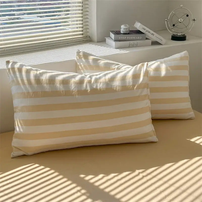 Cream striped quilt duvet cover Decorbites with a pair of beige striped pillows on Tampa Home & Garden Store