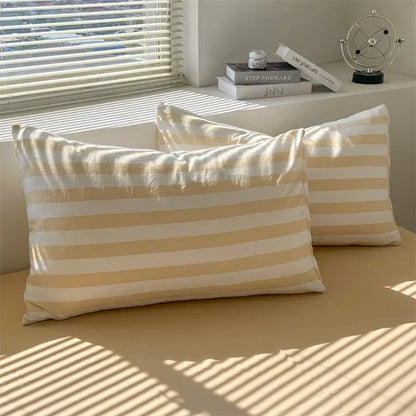 Cream striped quilt duvet cover Decorbites with a pair of beige striped pillows on Tampa Home & Garden Store