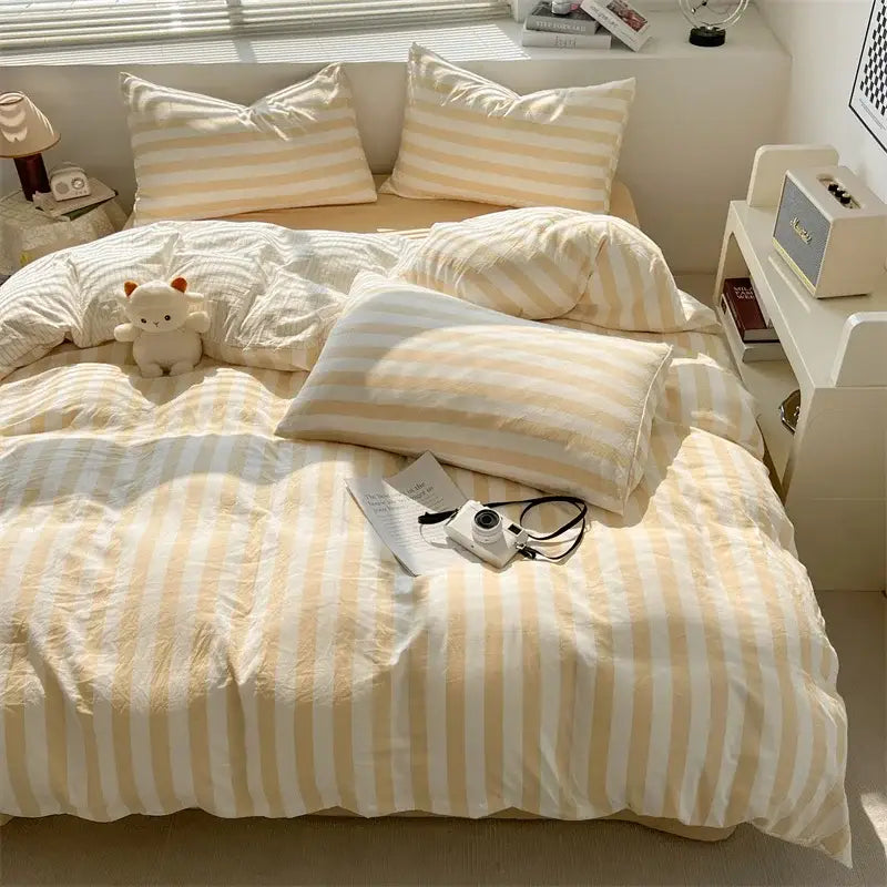 Cream striped quilt duvet cover by Decorbites in a sunlit bedroom with matching striped pillows on Tampa Home & Garden Store