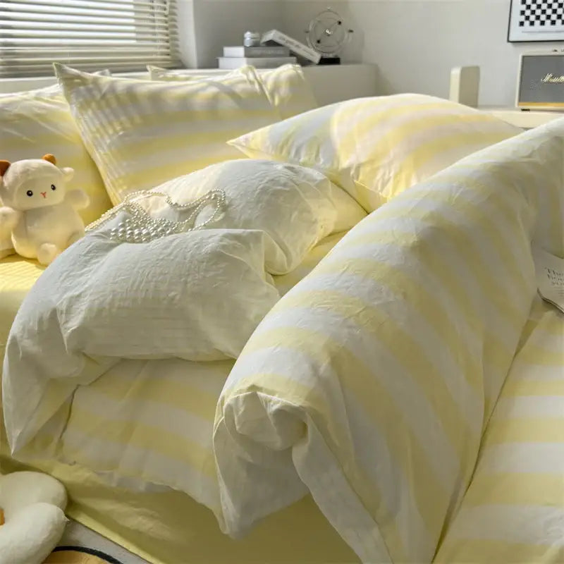 Cream striped quilted duvet cover with pale yellow stripes on a bed on Tampa Home & Garden Store