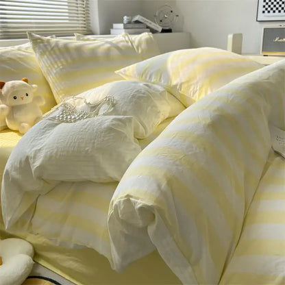 Cream striped quilted duvet cover with pale yellow stripes on a bed on Tampa Home & Garden Store