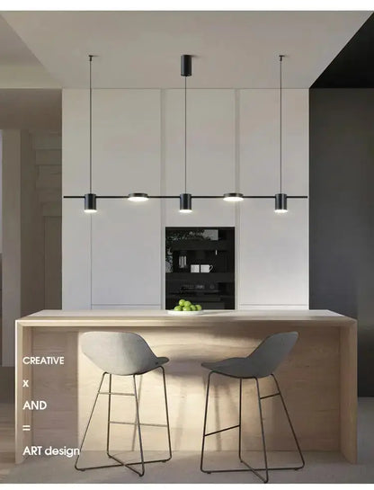 Chandelier Decorbites modern black metal LED with four pendants over light wood island on Tampa Home & Garden Store
