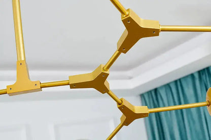 Decorbites chandelier; gold metal Nordic geometric frame with interconnected angular arms on Tampa Home & Garden Store