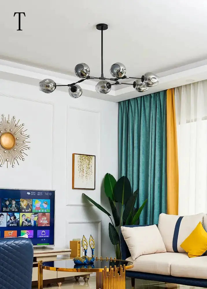 Chandelier Decorbites amber glass, black metal arms, ceiling mount, six globes in living room on Tampa Home & Garden Store