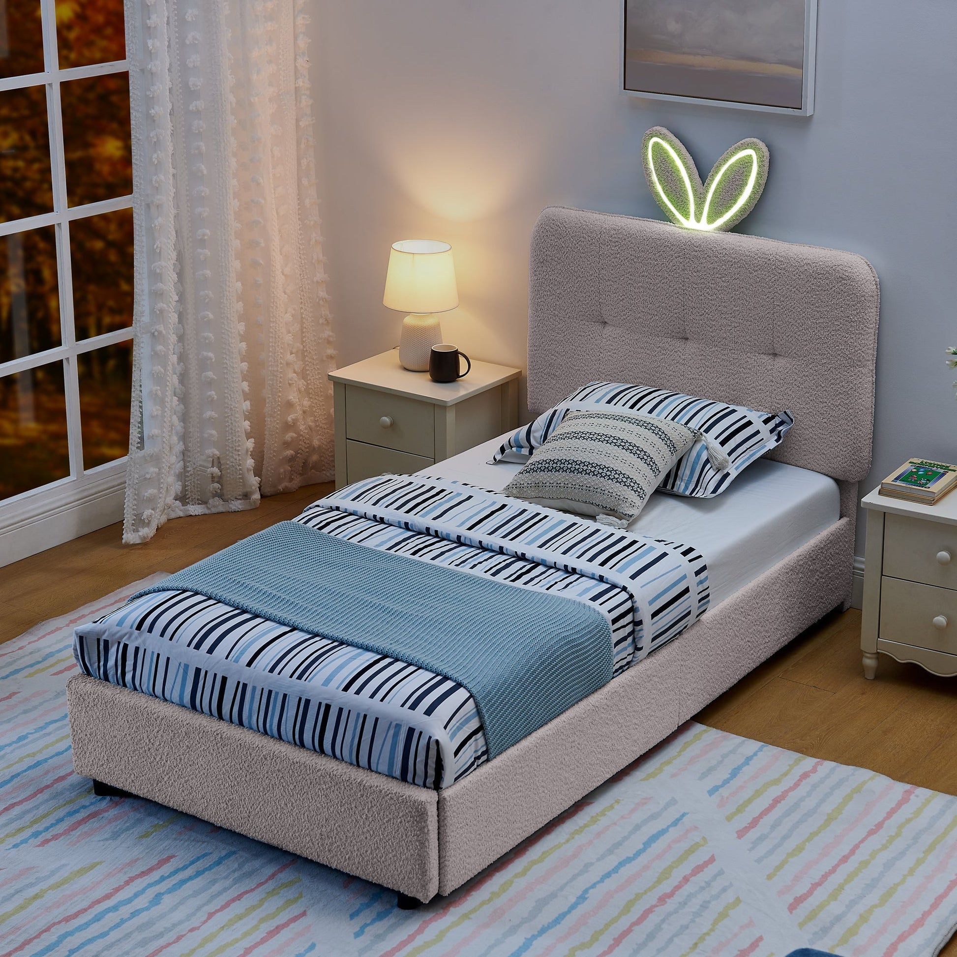 Two twin size kids upholstered beds with oversized rabbit ear headboards in grey fabric on Tampa Home & Garden Store