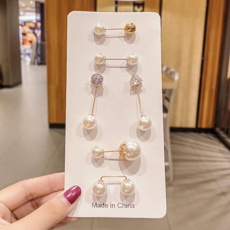Pearl earrings set on white display card with gold-tone pins and crystals on Tampa Home & Garden Store