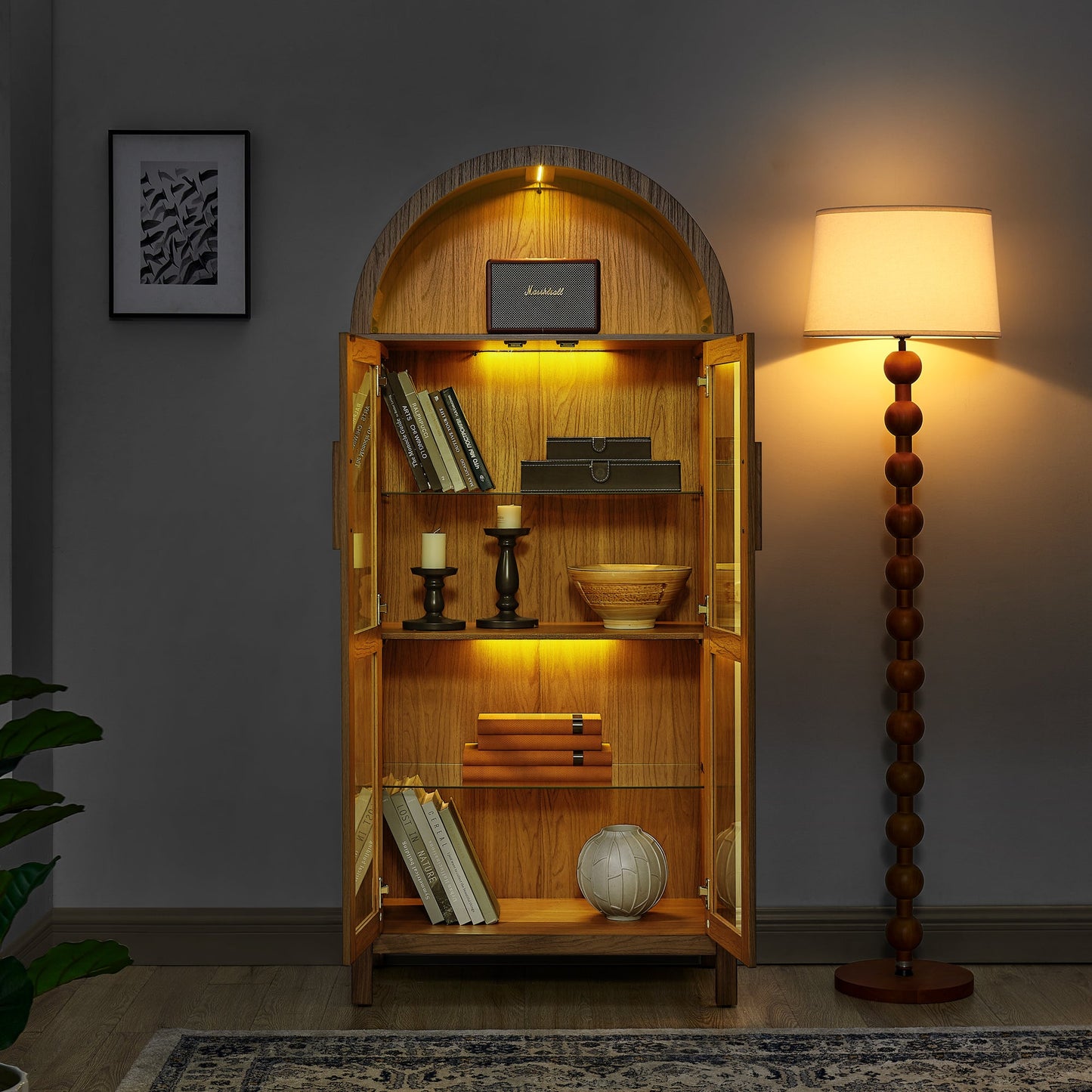 High Arched Storage Cabinet with Lamp, oak finish, glass doors, warm lighting, Marshall speaker on Tampa Home & Garden Store