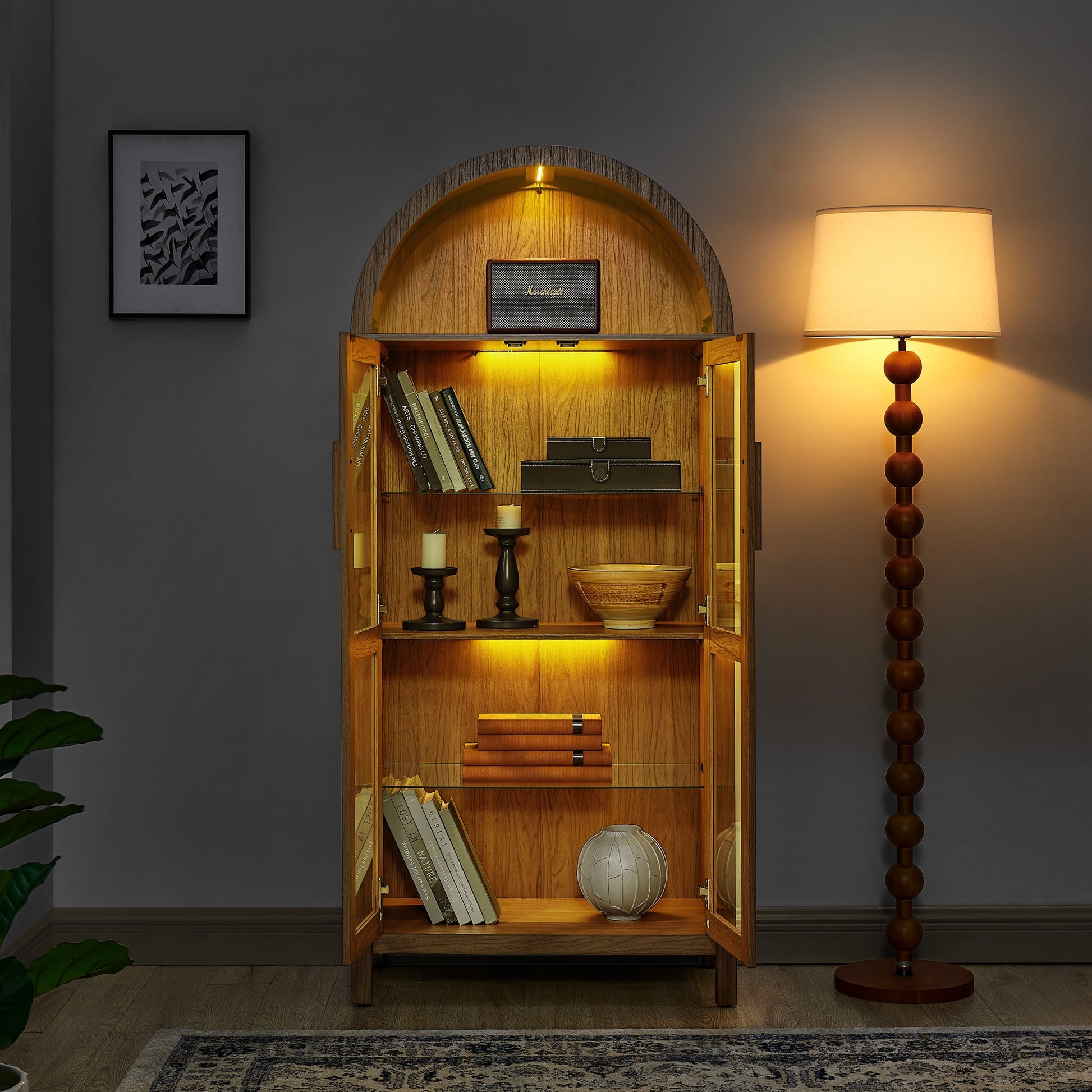 High Arched Storage Cabinet with Lamp, oak finish, glass doors, warm lighting, Marshall speaker on Tampa Home & Garden Store