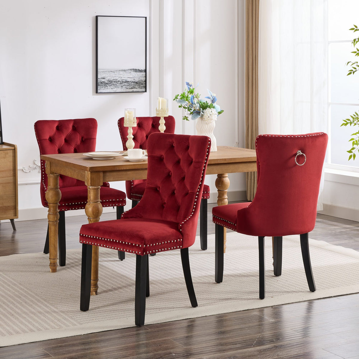 Four burgundy velvet dining chairs with tufted backs around a wooden table on Tampa Home & Garden Store
