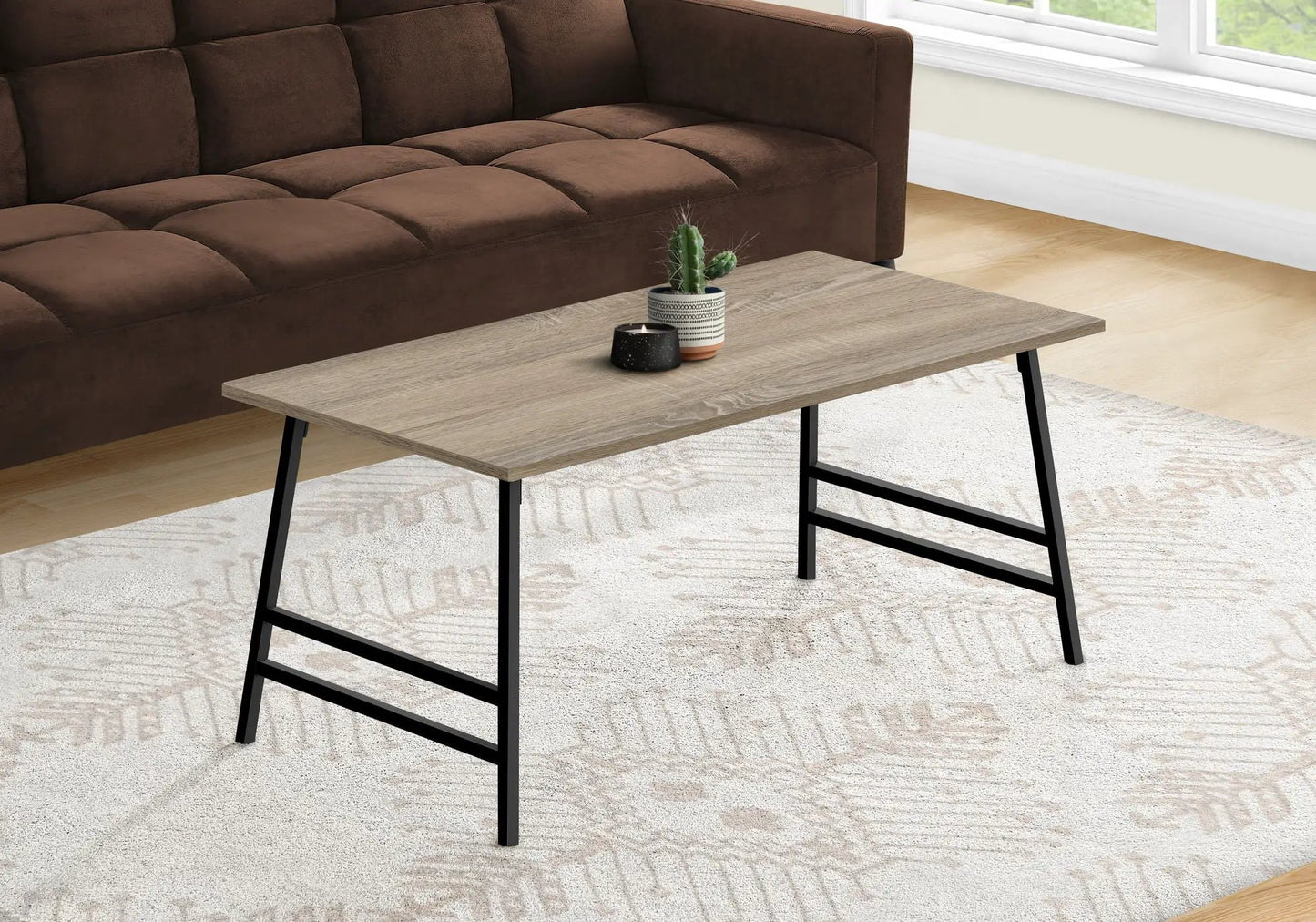 Rectangular modern coffee table with light wood top and black metal legs on Tampa Home & Garden Store