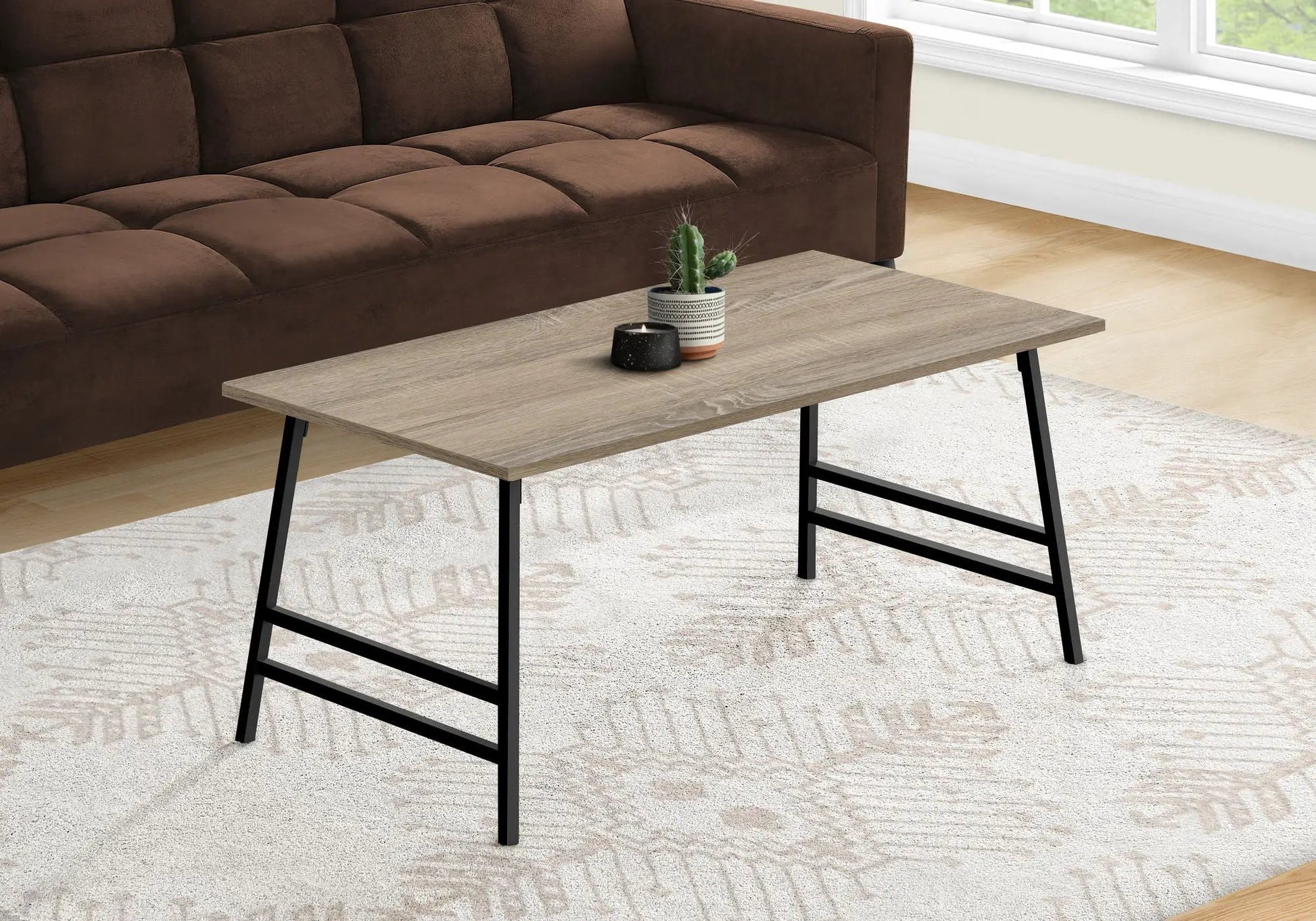 Rectangular modern coffee table with light wood top and black metal legs on Tampa Home & Garden Store