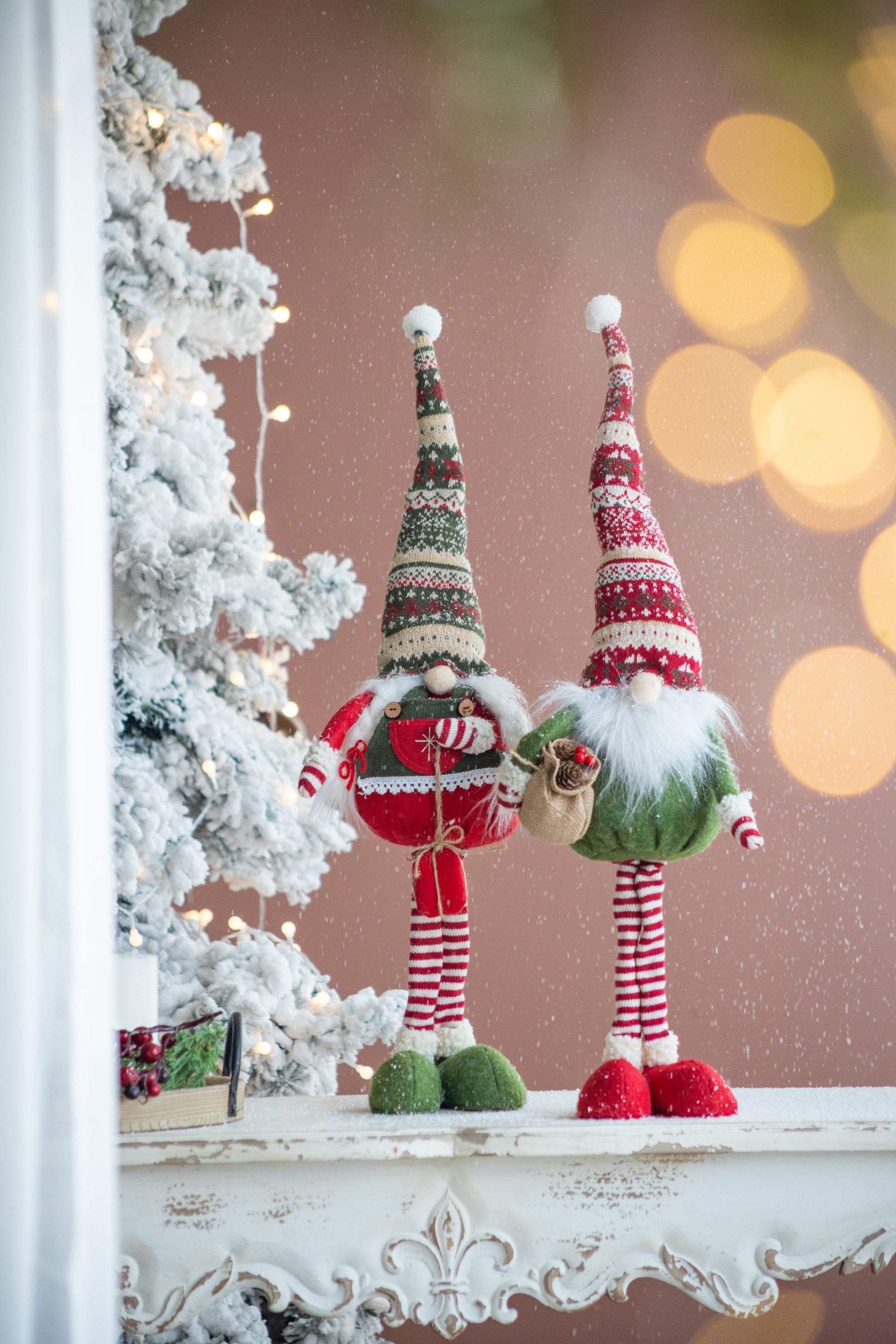 Set of 2 fabric standing holiday gnomes with red and green striped knit hats, snow base on Tampa Home & Garden Store