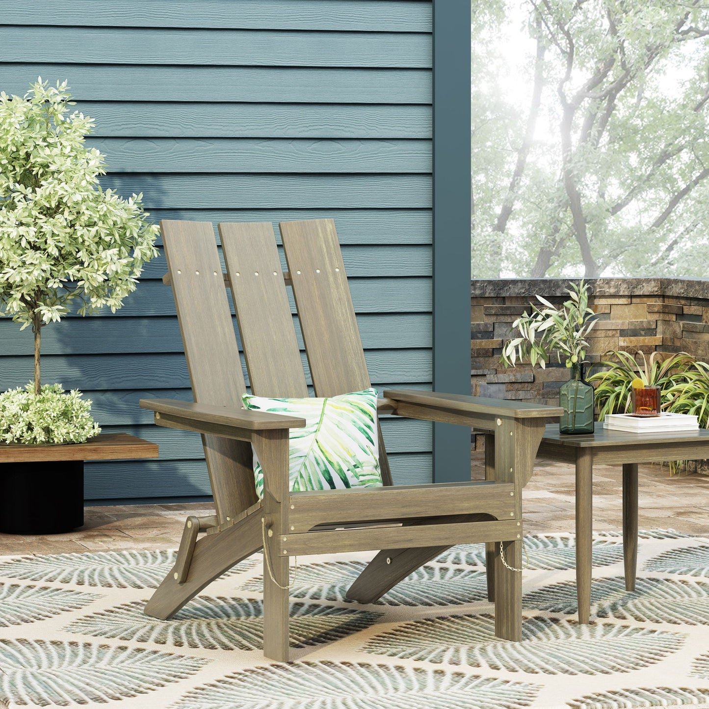 Aurascape foldable Adirondack chairs in weathered gray wood with tropical leaf cushions on patio on Tampa Home & Garden Store