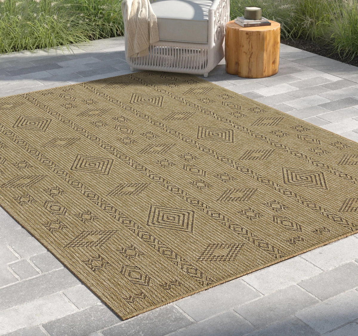 Mocha jute flatweave rug with geometric diamond pattern, outdoor indoor rug on a stone patio on Tampa Home & Garden Store