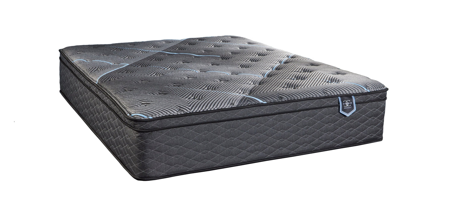 Restonic ComfortCare Hybrid California King mattress with euro top in dark gray quilted fabric Restonic label visible on Tampa Home & Garden Store
