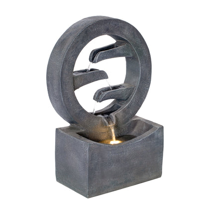 Gray circular polyresin outdoor fountain with LED light and cascading water through inner rings on Tampa Home & Garden Store