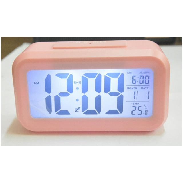 Stevvex pink battery-operated digital alarm clock with blue LED display and date readouts on desk on Tampa Home & Garden Store