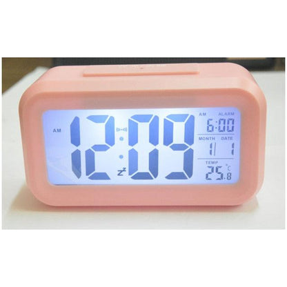 Stevvex pink battery-operated digital alarm clock with blue LED display and date readouts on desk on Tampa Home & Garden Store