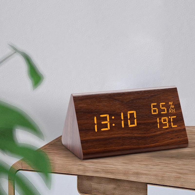 Stevvex wooden digital alarm clock with LED time display shows 13:10, 65% RH and 19°C on desk on Tampa Home & Garden Store